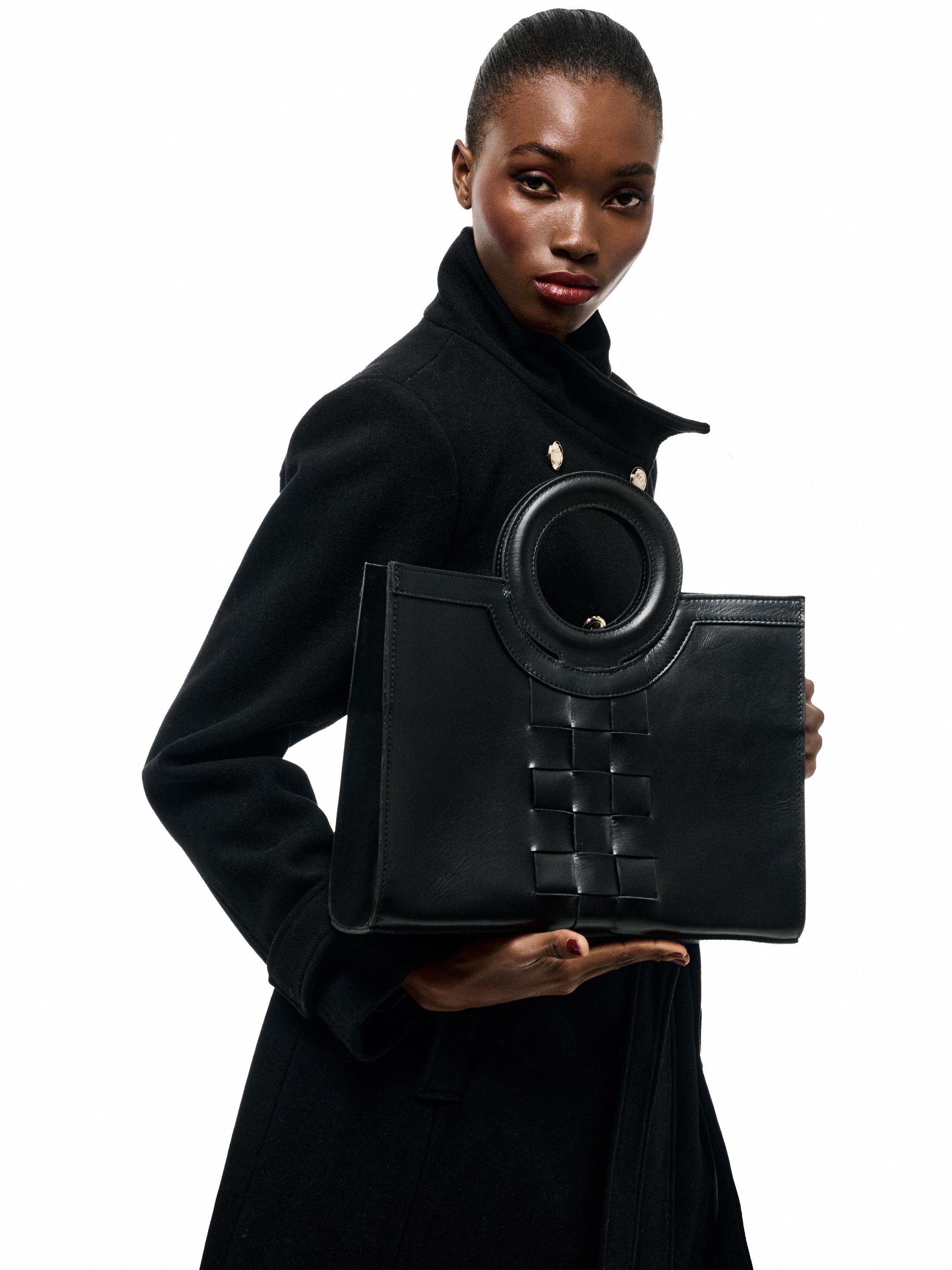 EUTERPE - The Holy Bag tote bag in black leather, knitted design and round handles. Shoulder strap.